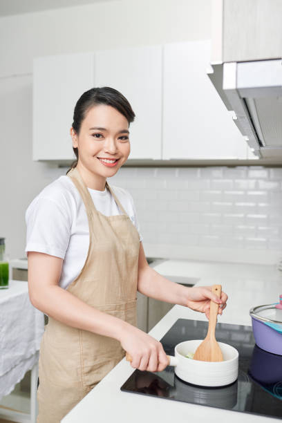 istock Young woman cooking in the kitchen 1244654995