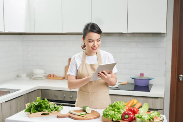 istock Young woman cooking in the kitchen 1244655530