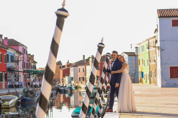 istock happy wedding couple posing near dock in italy 1244656048