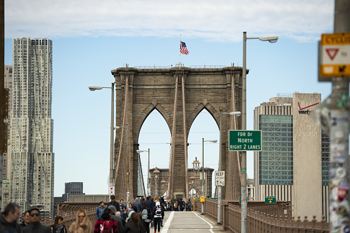 New York, USA, May 4, 2020. Some people are walking on the Brooklyn Bridge during the Covid-19 outbreak. The Brooklyn Bridge is a hybrid cable-stayed/suspension bridge in New York City, USA.