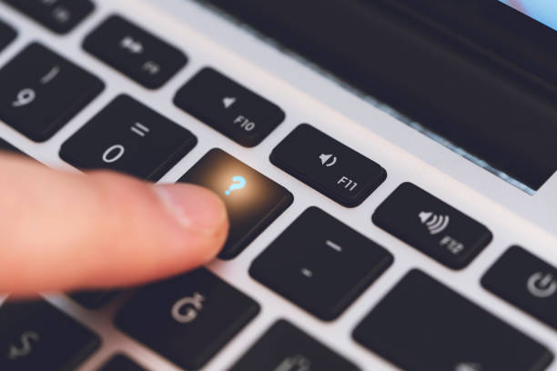 istock Closeup of Man's Finger Touching the Letter Question Mark Key on Black Computer Keyboard 1244679244