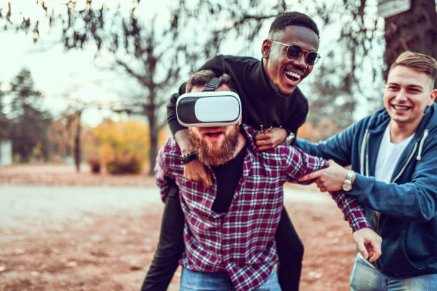istock Friends Joking With Their Friend While He Tries VR For The First Time 1244695208