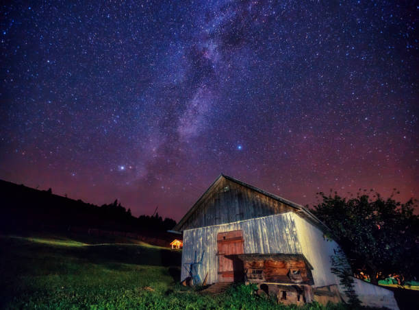 istock View at the starry sky and old house on mountain slope. 1244696312