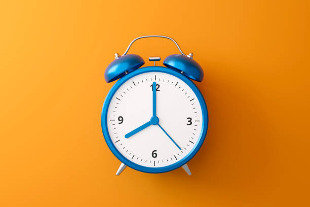 istock Blue alarm clock on orange background with complementary color and retro style. Classic analog clock and blank space. 3D rendering. 1244698565