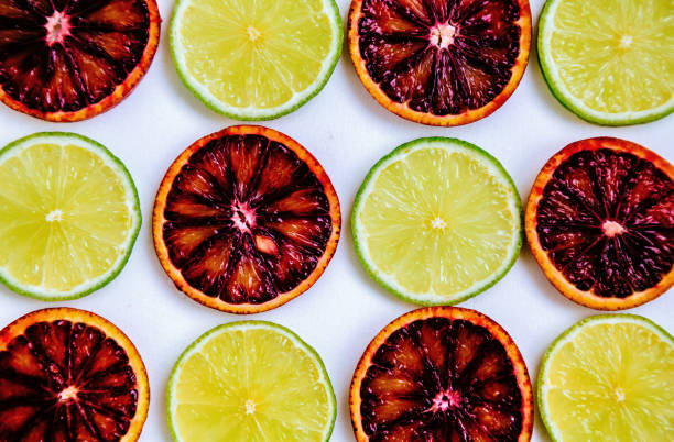 Red orange and lime fruits isolated on white background.