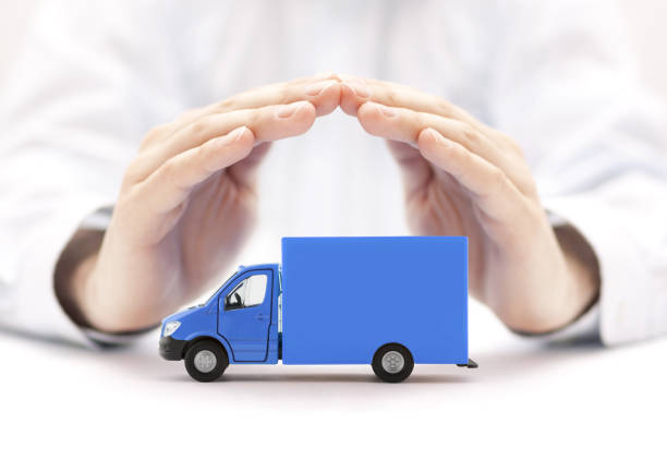 istock Blue cargo delivery truck protected by hands 1244711405