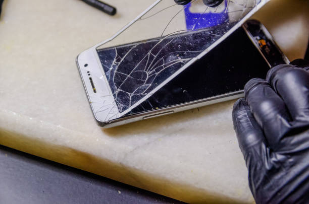 istock Technician or engineer opening broken smartphone for repair or replace new part on desk 1244723687