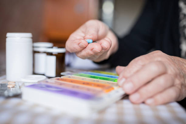 istock Old woman holding a pill 1244729729