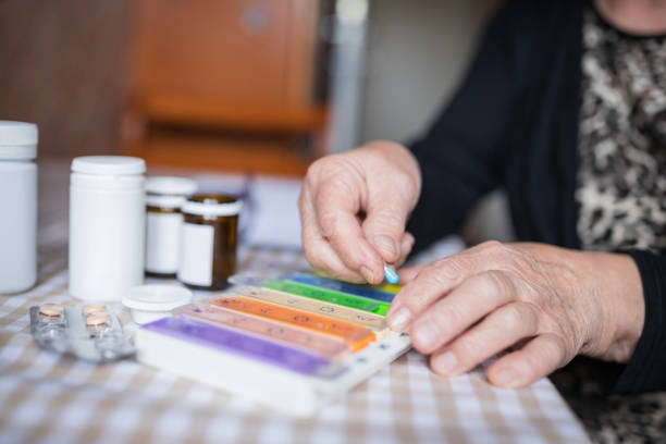 istock Senior woman holding daily pill container 1244731482