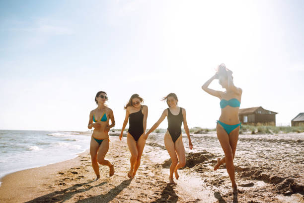 istock Happy four girls having fun on the beach. 1244739251