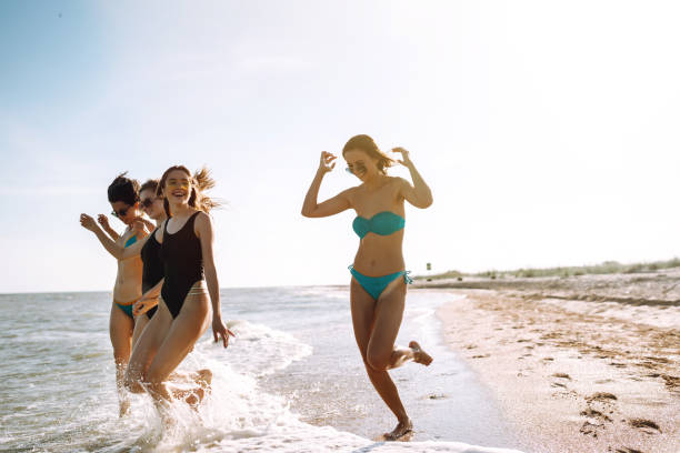 istock Happy four girls having fun on the beach. 1244739776