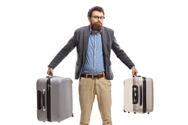 istock Confused bearded man holding suitcases 1244739822