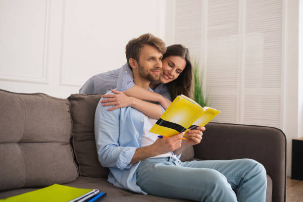 istock Young man studying before exam, his wife hugging him and smiling 1244753295