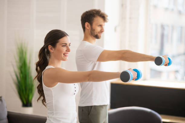 istock Dark-haired woman and her husband having workout together and feeling great 1244753918