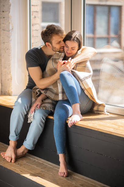 istock Young bearded man hugging his wife and looking happy 1244754492