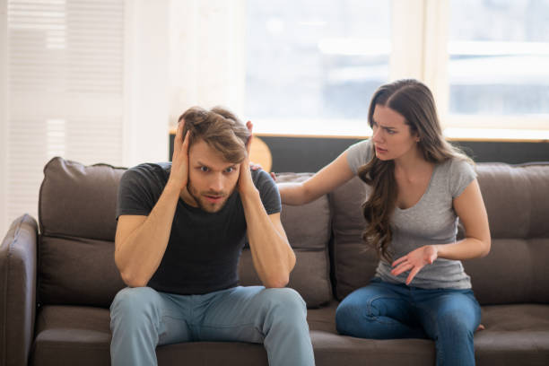 istock Long-haired young woman blaming her husband while he closing his ears 1244754545