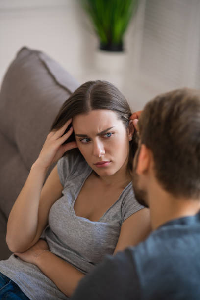 istock Young pretty woman looking disturbed while her husband talking to her 1244755103