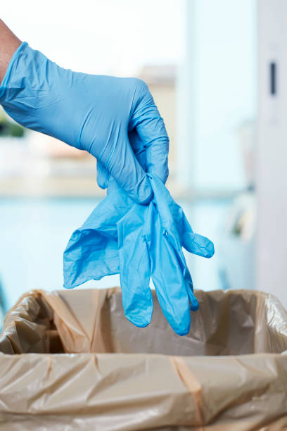 istock man throwing latex gloves to the trash can 1244755727