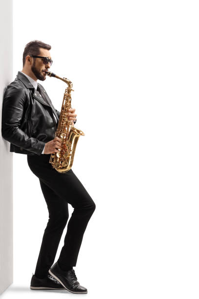 istock Handsome young male musician in a leather jacket playing a saxophone 1244755744