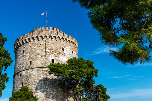 Thessaloniki, Greece - August 21, 2014:The White Tower of Thessaloniki (Greek: Λευκός Πύργος Lefkós Pýrgos) is an Ottoman fortress & former prison on the waterfront housing an interactive exhibition of the city's history.