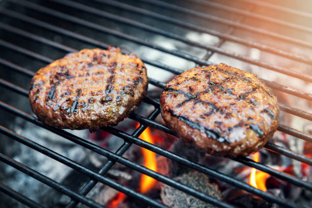 istock beef burger meat cooking on charcoal grill outdoors 1244767310
