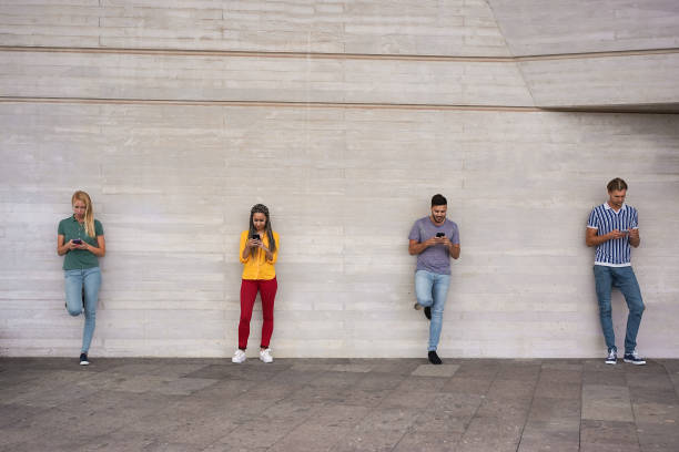 istock Young people using smart mobile phones while keeping social distance during coronavirus time - Technology, covid-19 spread prevention and lifestyle concept - Main focus on center guys 1244776497