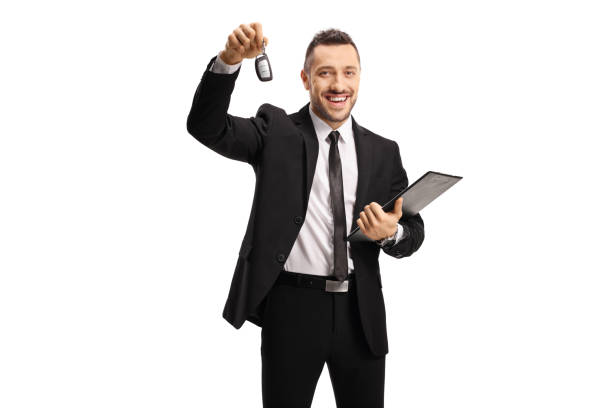 istock Smiling man in a suit showing a car key 1244816856