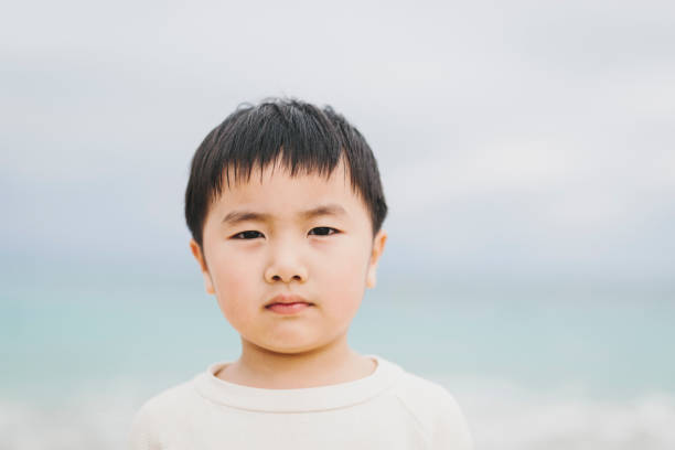 Asian boy relaxed in the beach in Okinawa.