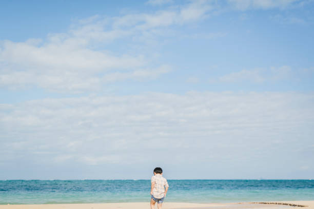 Asian boy relaxed in the beach in Okinawa.