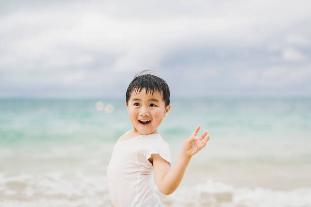 Little girl is running on the beach