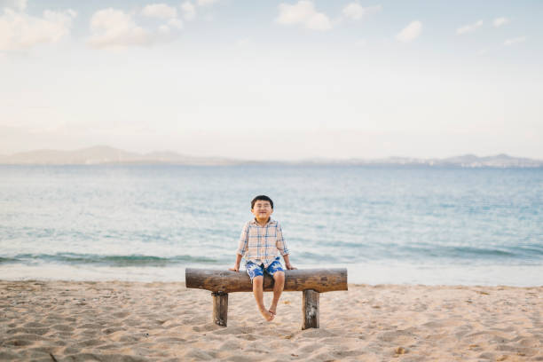 Asian boy relaxed in the beach in Okinawa.