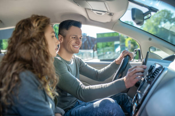 istock Couple sitting in the car ready for the test driving 1244846034