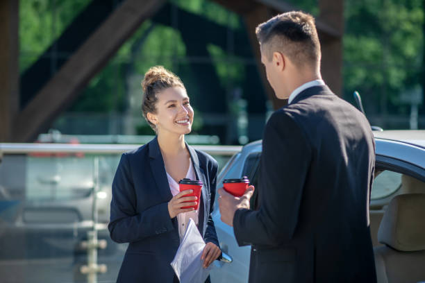 istock Successful woman with coffee and papers and man standing 1244847147