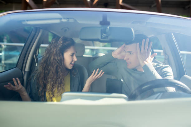 istock Young man and woman sorting out relationships in a car 1244848416