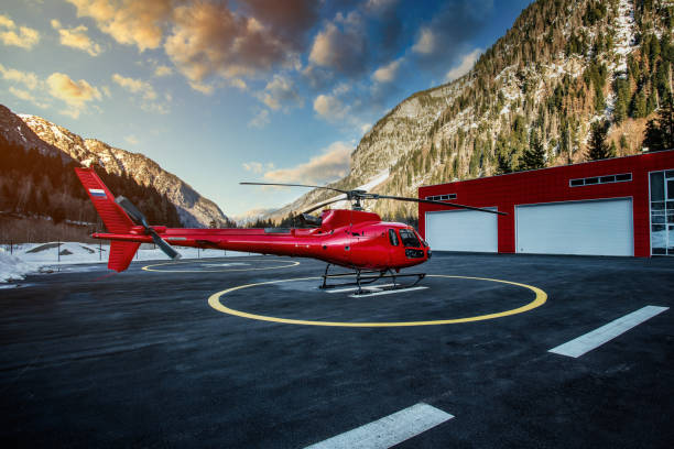 istock Red helicopter at helipad on sunset. 1244858449