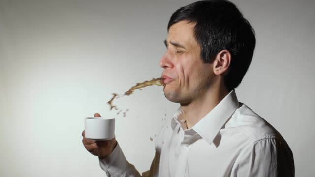 Man spits out hot or tasteless coffee