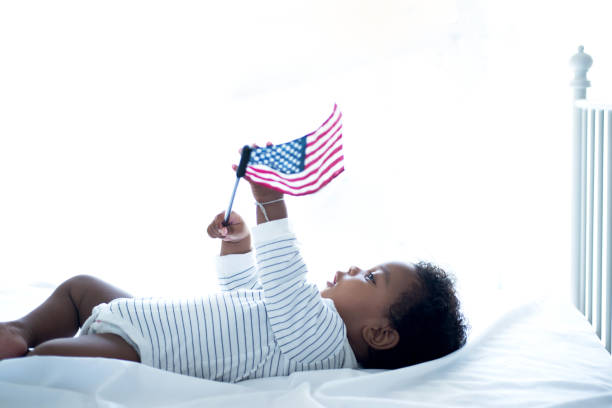 Cute little dark skinned is cute holding American flag