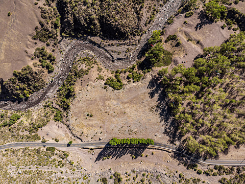 Aerial view of a road running beside Volcan river at Cajon del Maipo in the central Chile Andes