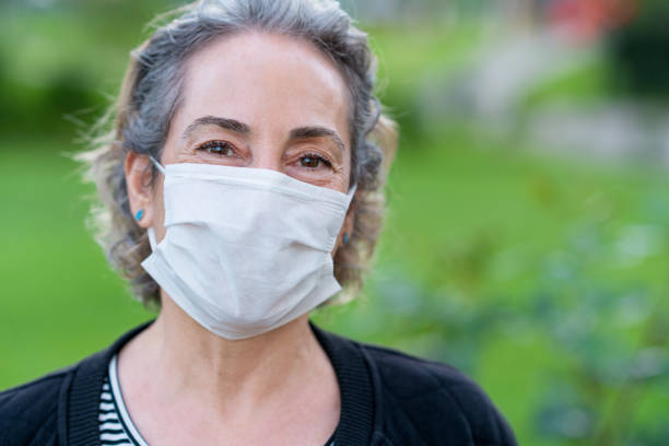 istock Senior woman with protective face mask 1244901521