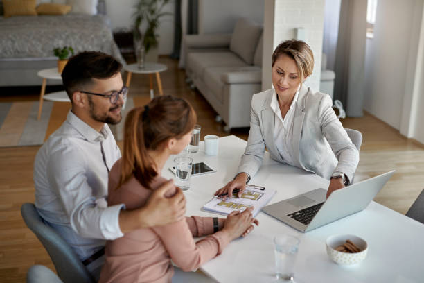 istock Above view of real state agent and couple using laptop a meeting. 1244902664