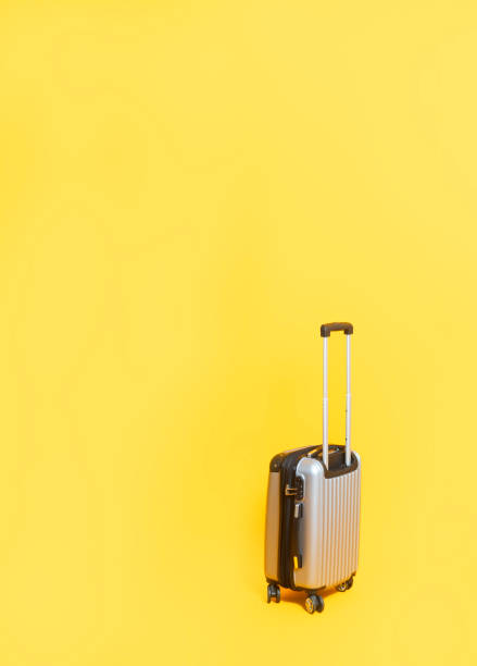 istock Travel bag with zipping number code locked. Silver suitcase number code lock on yellow background with copy space. 1244906761