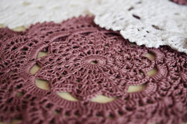 istock White and purple hand hooked coaster. Knitted holders for hot work 1244909760