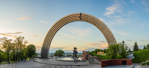 People relax and enjoy the views from People's Friendship Arch, Kyiv, Ukraine