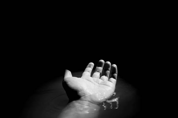 Begging hand in water stock photo