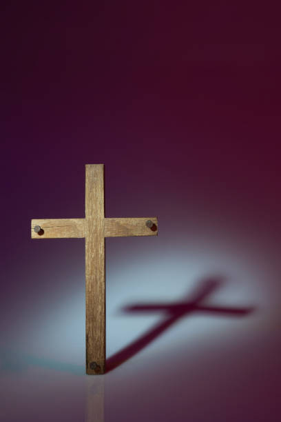 istock Wooden cross photograph with harsh lighting 1244918312