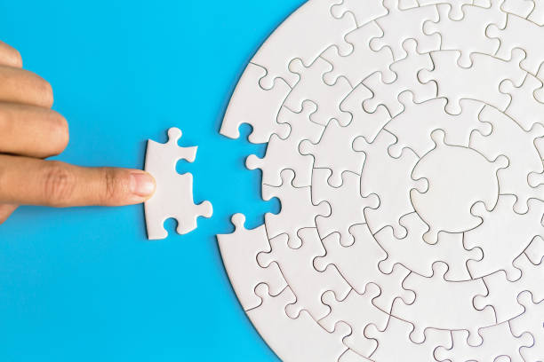 Hand put the last piece of jigsaw puzzle to complete the mission. Completing final task, missing jigsaw puzzle pieces and business concept with a puzzle piece missing. Hand put the last piece of jigsaw puzzle to complete the mission. Completing final task, missing jigsaw puzzle pieces and business concept with a puzzle piece missing. jigsaw piece photos stock pictures, royalty-free photos & images