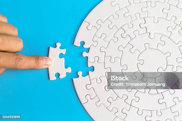 Hand Put The Last Piece Of Jigsaw Puzzle To Complete The Mission Completing Final Task Missing Jigsaw Puzzle Pieces And Business Concept With A Puzzle Piece Missing Stock Photo - Download Image Now