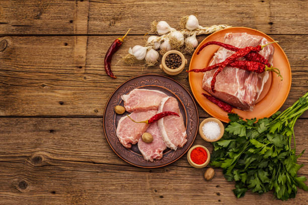 istock Assorted raw pork meat. Fresh loin, spices, fragrant vegetables and parsley 1244932481