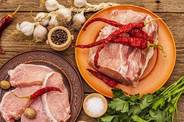 istock Assorted raw pork meat. Fresh loin, spices, fragrant vegetables and parsley 1244932518