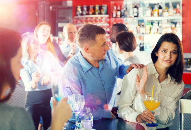 Man trying to seduce female colleague Tipsy man trying to seduce young female colleague on office party at nightclub vex nightclub stock pictures, royalty-free photos & images
